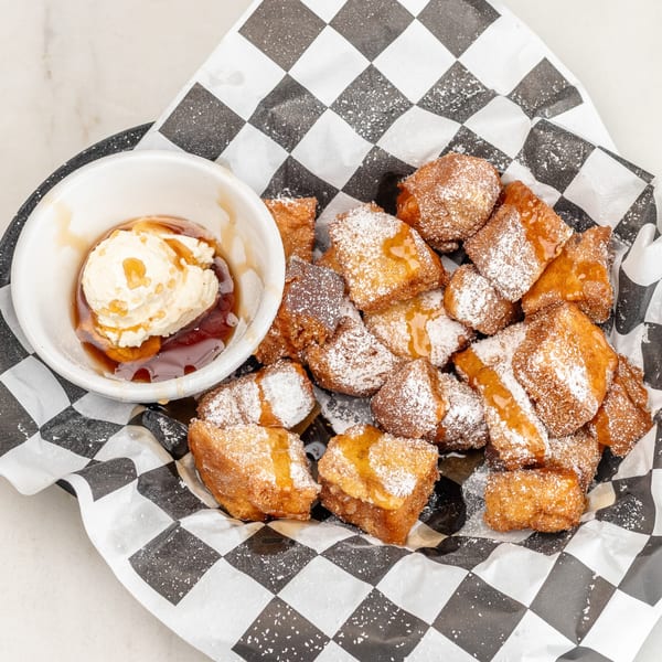 University Diner's fried dough bites with powdered sugar, syrup, and a side of vanilla ice cream.